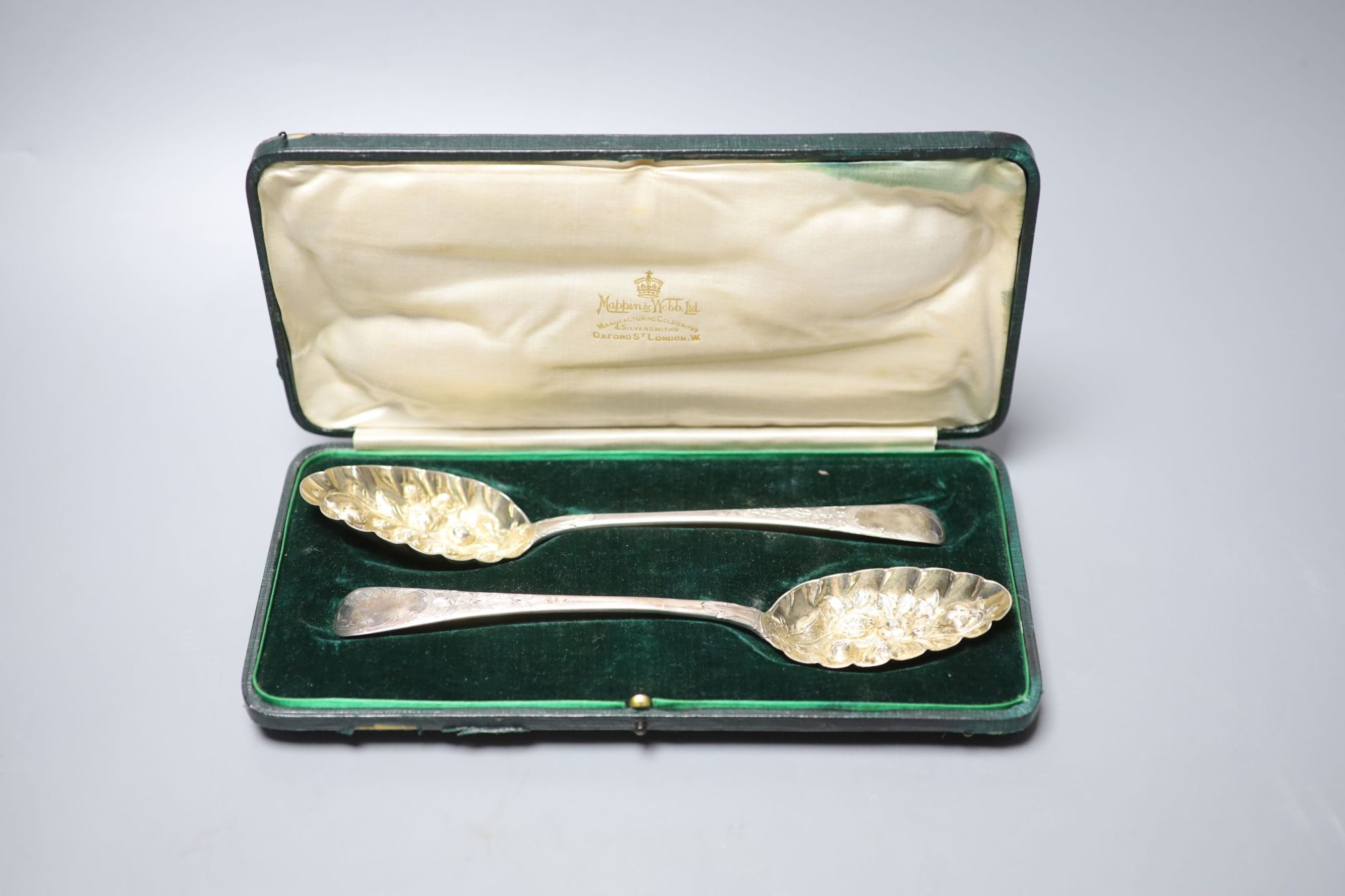 A pair of George III later embossed berry spoons, John Lias, London, 1817, 22.5cm